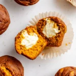 Pumpkin Cream Cheese Muffin sliced open with cream cheese filling