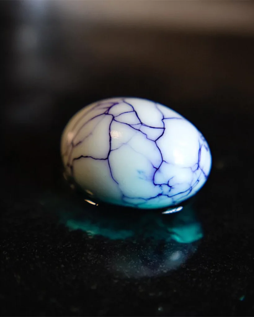Cracked Halloween eggs soaking in dye